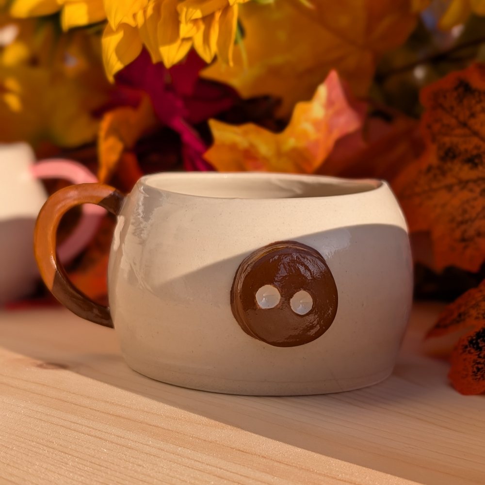 Handled mug with a brown button snout and matching handle