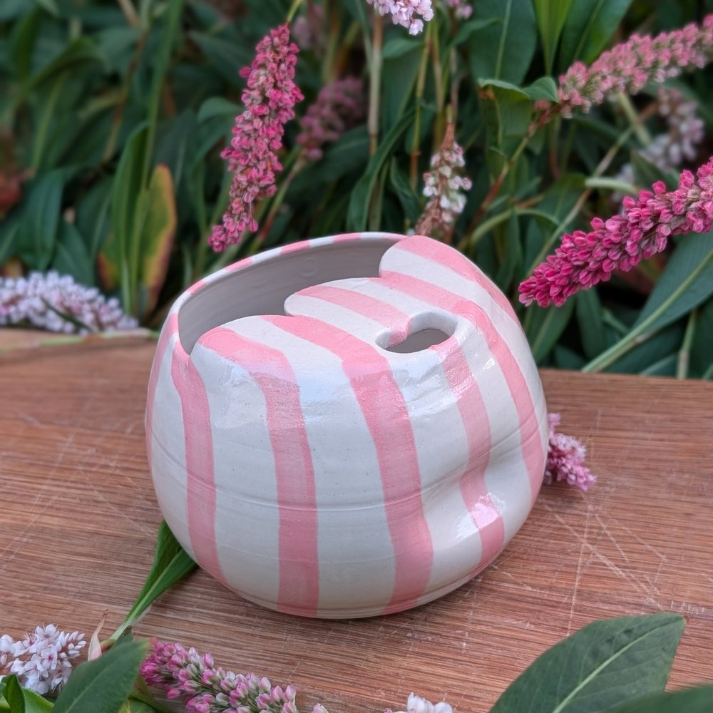 Lidded travel mug with hand-painted pink stripes and a heart-shaped sip hole